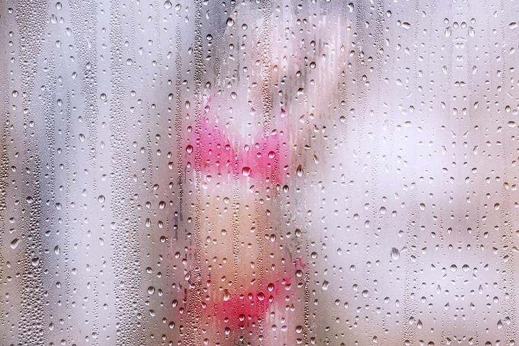 porn: a blurred image of a women clad in pink lingerie seen behind a fogged glass