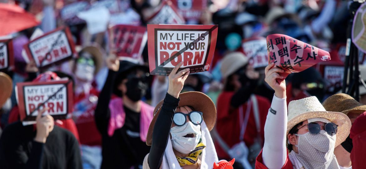 picture of people at a protest to "free porn" holding up placards