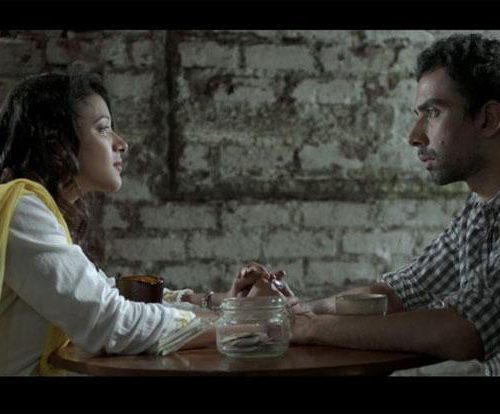 Still from 'Interior Cafe Night': a couple sits facing each other