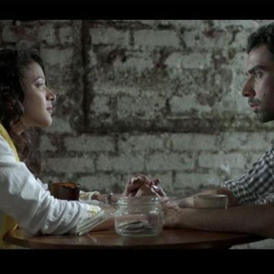 Still from 'Interior Cafe Night': a couple sits facing each other