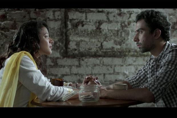 Still from 'Interior Cafe Night': a couple sits facing each other