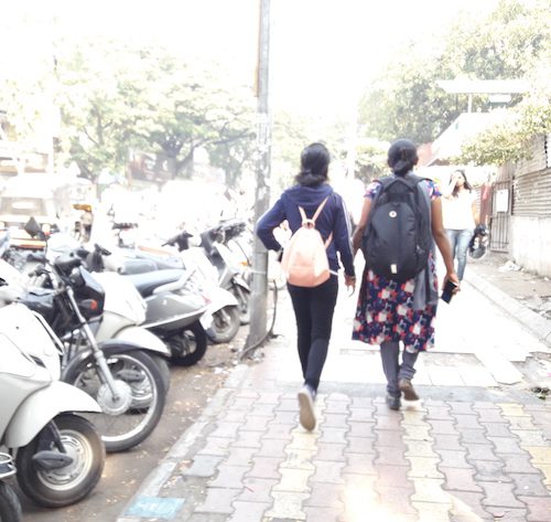 two women walking down a street