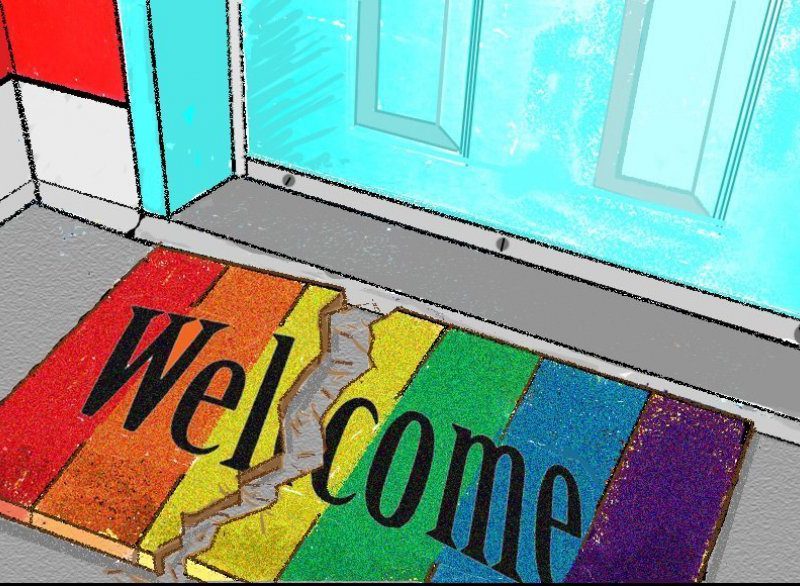 A welcome mat with the rainbow flag on it, it is torn in the middle