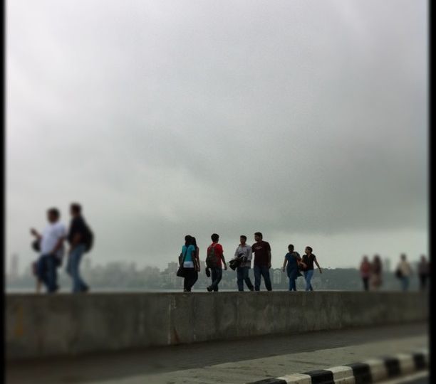 A group of people standing in a line at Mumbai's Marine Drive