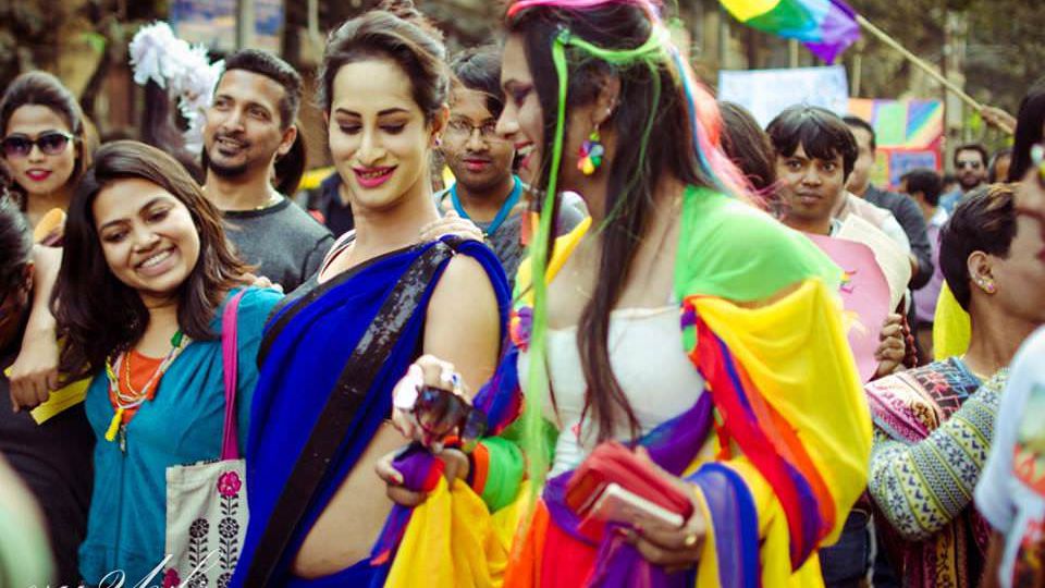 People marching at queer pride, with colourful clothes on