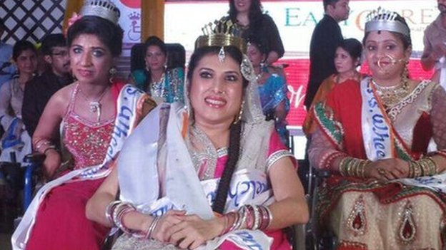 Picture of a woman dressed in a saree sitting on a wheelchair