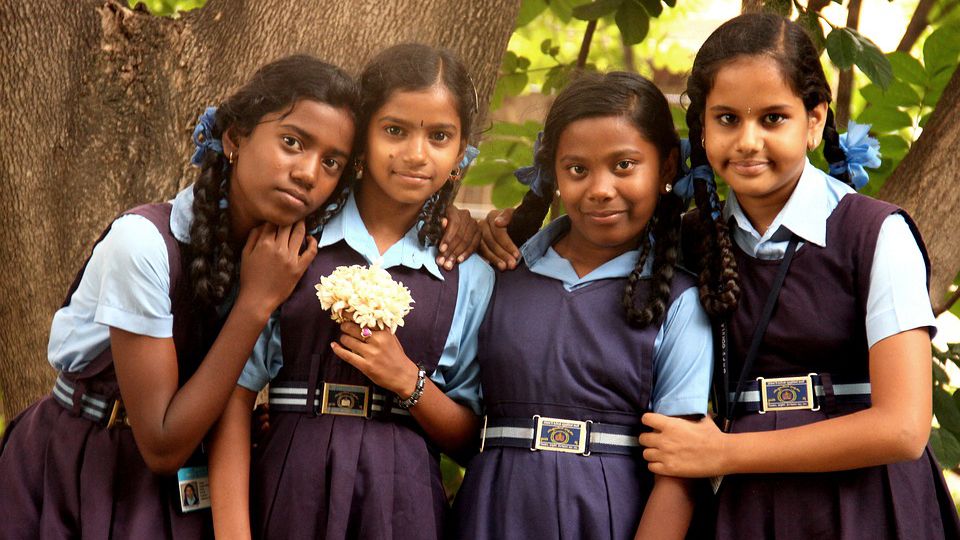 A picture of a group of young girls in school uniform