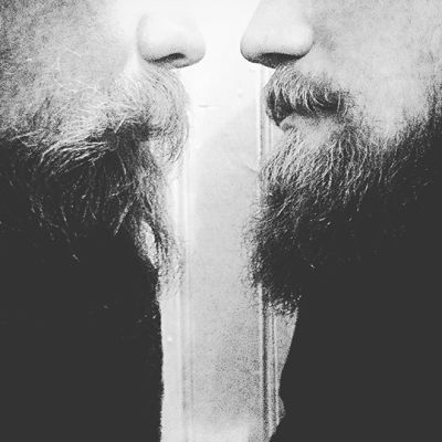 Two men with beards face each other