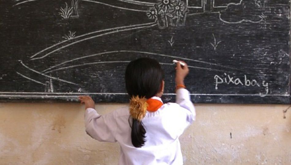 picture of a young girl writing on the blackboard