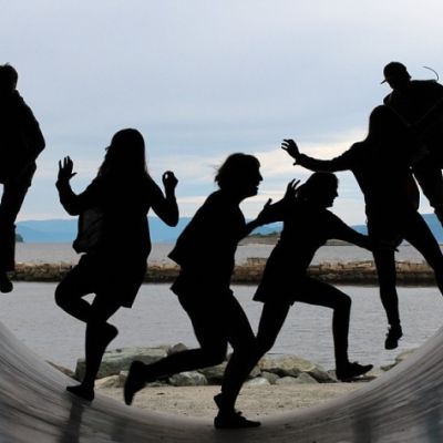 A photograph of many people’s silhouettes having fun in a semi-circular course