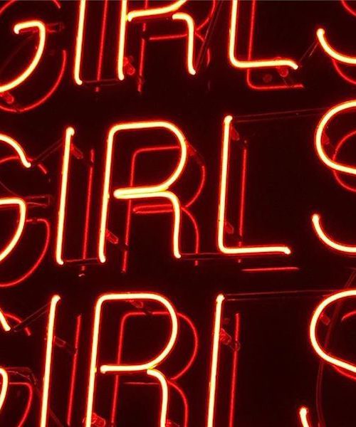 Neon-lit red typography saying GIRLS