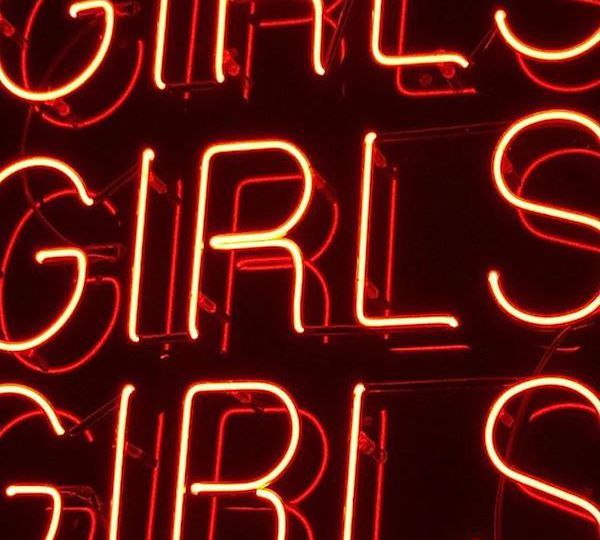 Neon-lit red typography saying GIRLS