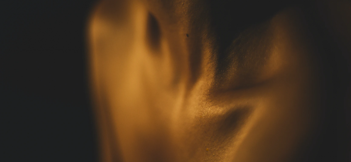 A photograph of an individual’s neck and shoulders, with a focus on the collarbone.