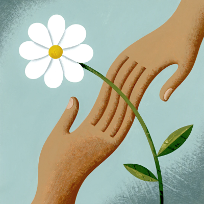 Picture of a white flower on a blue background. Two hands can be seen touching each other behind the flower