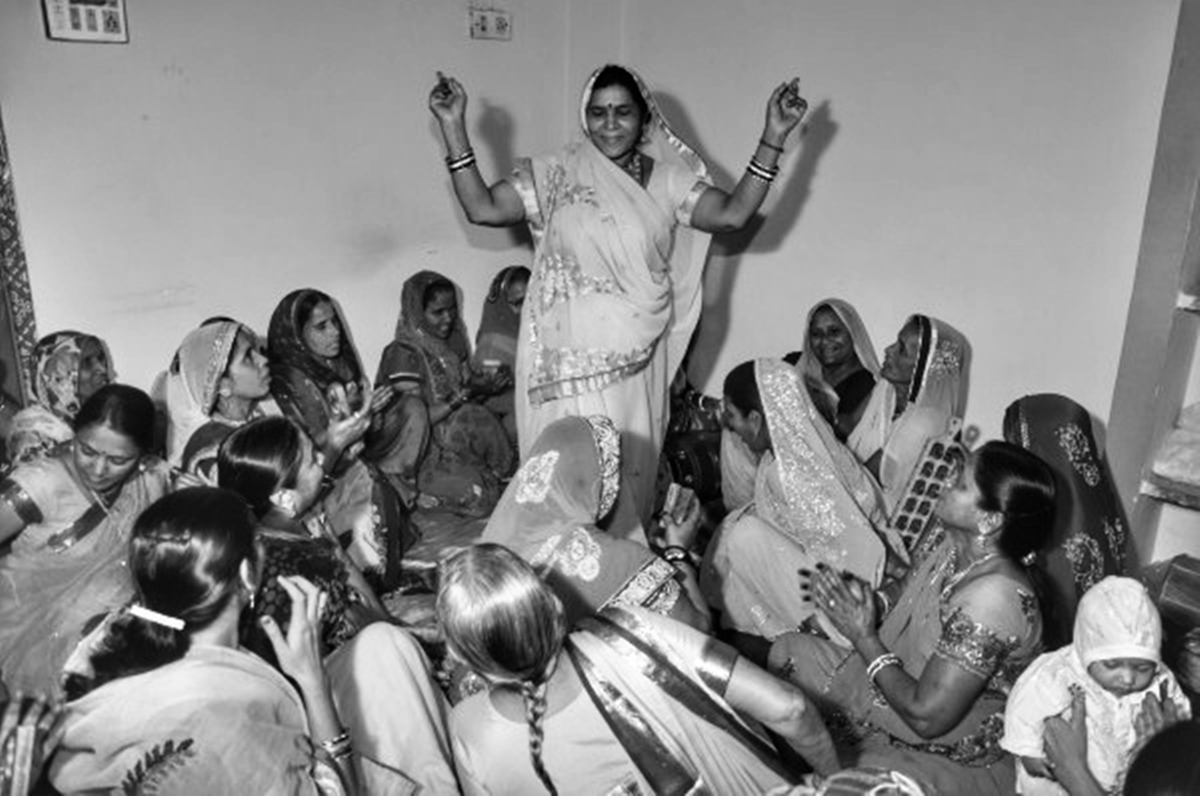 Women at Leisure: Women from a neighborhood got together for a wedding and help hosts attend to guests who have come from far and wide. Once done with the chores, they got together to sing and dance together.
