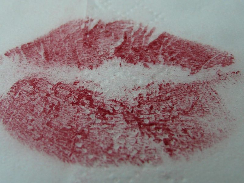 An impression of red lips on a white surface.