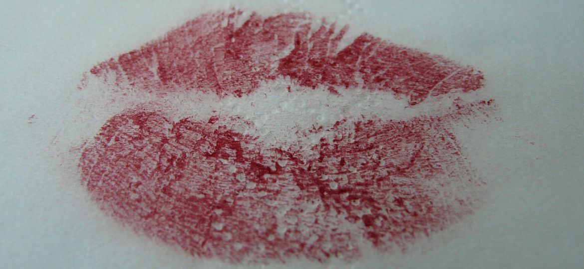 An impression of red lips on a white surface.