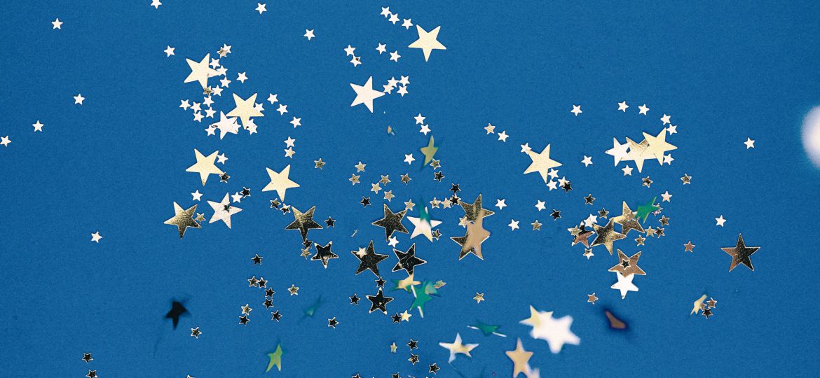 Artificial golden stars against a blue background
