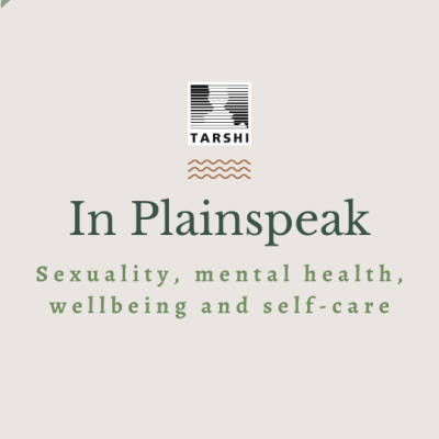 An illustration of the title of the article with a beige background. There are oblong-shaped blobs in peach and sap green on the upper left corner and the lower right corner. At the centre is the logo of TARSHI followed by three verticle rows of squiggly lines and the text that reads "In Plainspeak: Sexuality, mental health, wellbeing and self-care"
