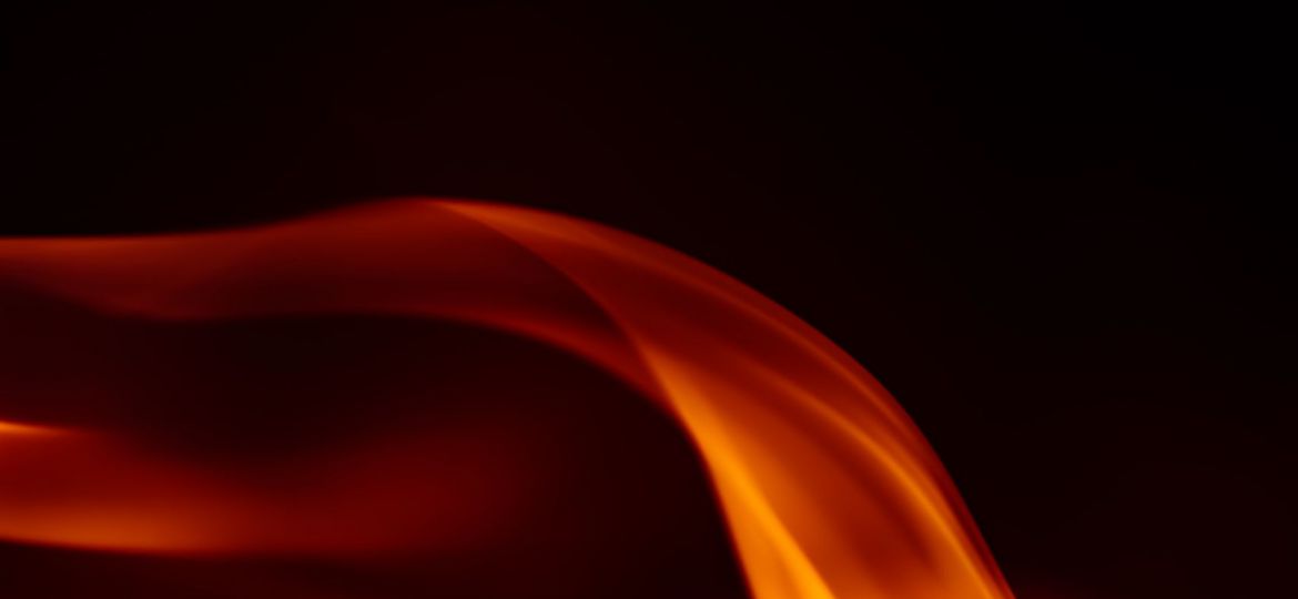 Orange flames rising over a black background