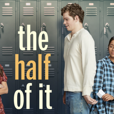 poster of the half of it with the red Netflix logo on the top left corner. a woman in a dress stands with folded arms looking at a tall man. hidden behind him is a woman in glasses handing him a note.