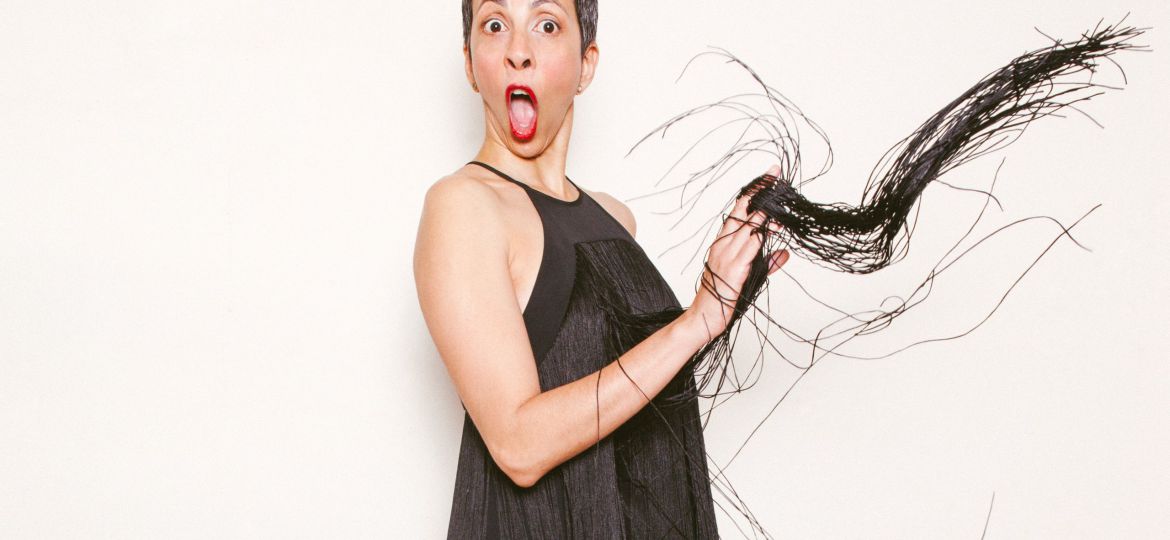 Photo of Radhika Vaz in a black flapper dress against a white background