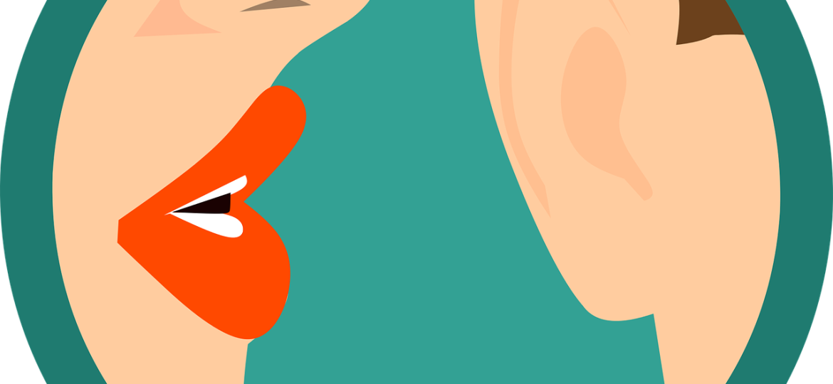 A colour illustration of a mouth whispering into an ear