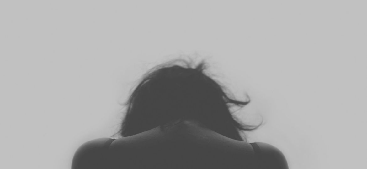 Grayscale photo of a person’s back