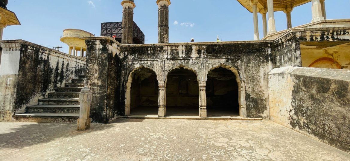 An old Rajasthani building with a lot of pillars and arches