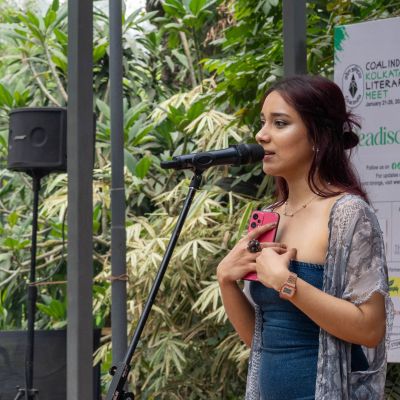 A photo of Sara Haque performing on stage