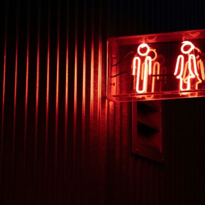 gender bathroom signage in red neon lighting