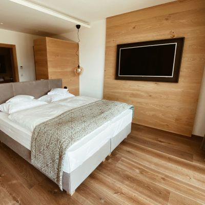 A hotel bedroom with the bed made in white linen