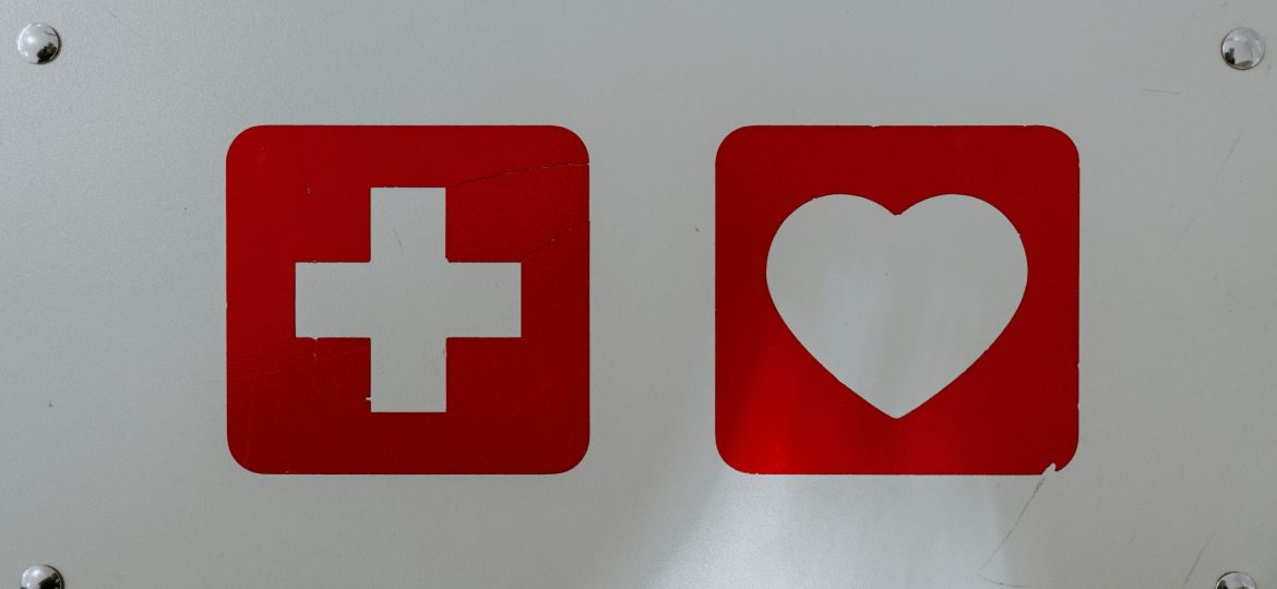 Two signs of plus and heart in red and white