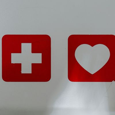 Two signs of plus and heart in red and white