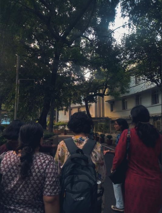 A photo of a group of friends walking on from behind