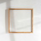 a square wooden frame hanging on a wall