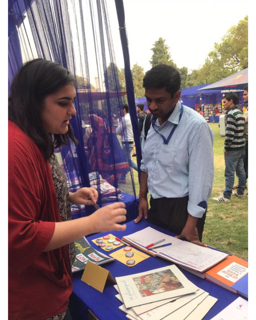 Untitled design At a festival where a male customer is looking at TARSHI publications.